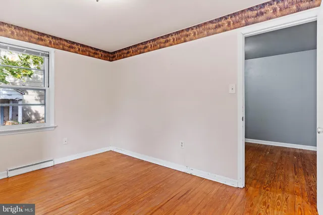 a view of a room with wooden floor and windows