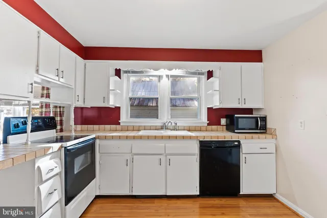 a kitchen with stainless steel appliances granite countertop a stove and a sink