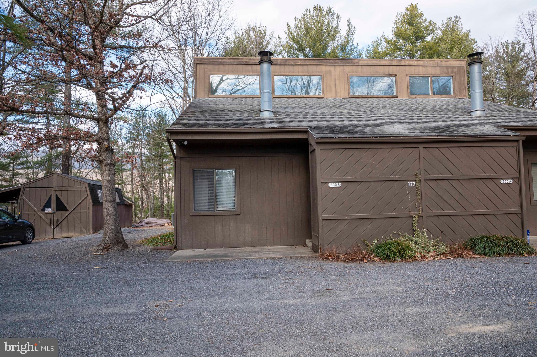 377 Spitz Lane, Unit 100 Basye, VA 22810 - Photo 36 of 69 a front view of a house with a yard and garage