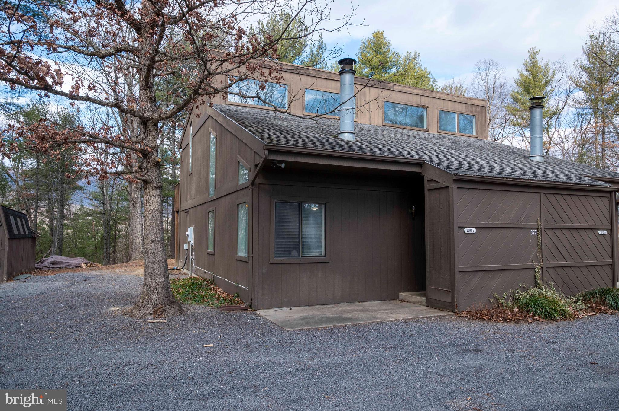 377 Spitz Lane, Unit 100 Basye, VA 22810 - Photo 41 of 69 a front view of a house with a yard and garage