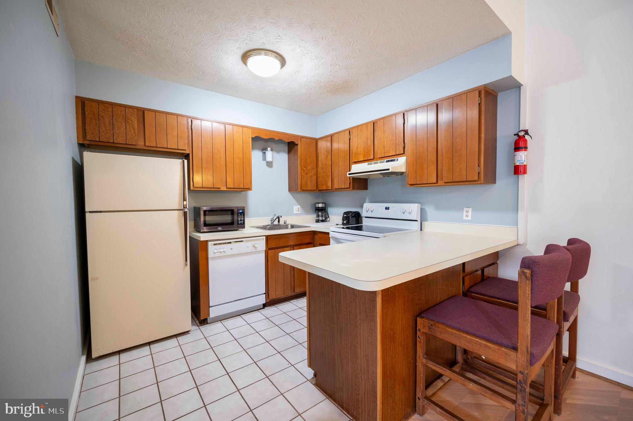 377 Spitz Lane, Unit 100 Basye, VA 22810 - Photo 48 of 69 a kitchen with a sink a refrigerator and a stove top oven