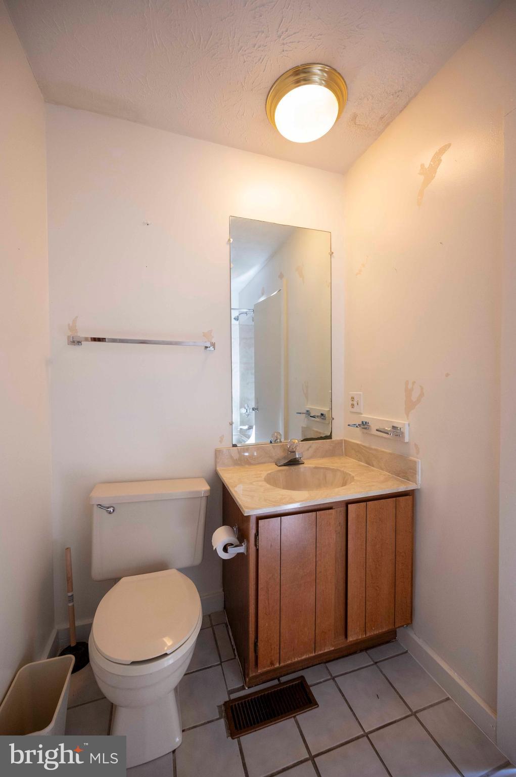 377 Spitz Lane, Unit 100 Basye, VA 22810 - Photo 63 of 69 a bathroom with a granite countertop toilet sink and mirror