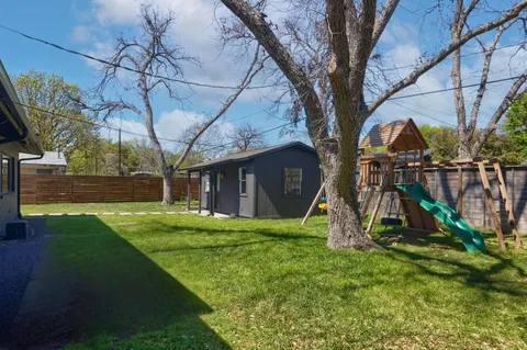a view of a backyard with a small cabin