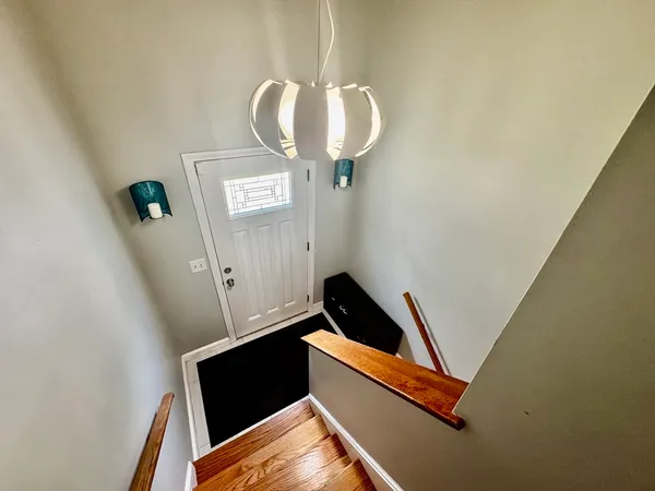 a room with wooden floor and white wall