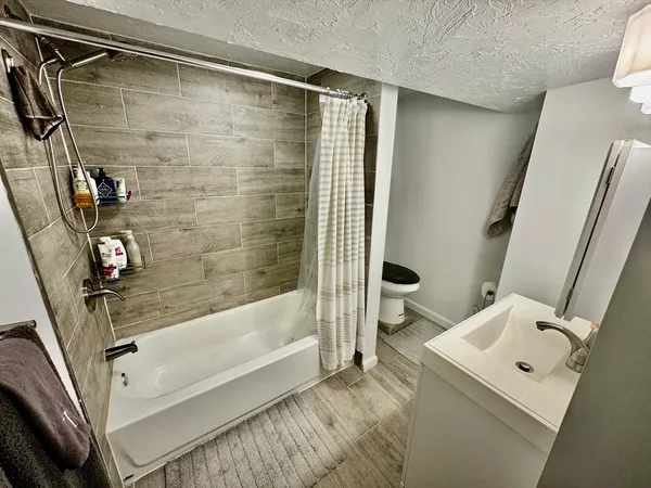 a bathroom with a bathtub and a shower