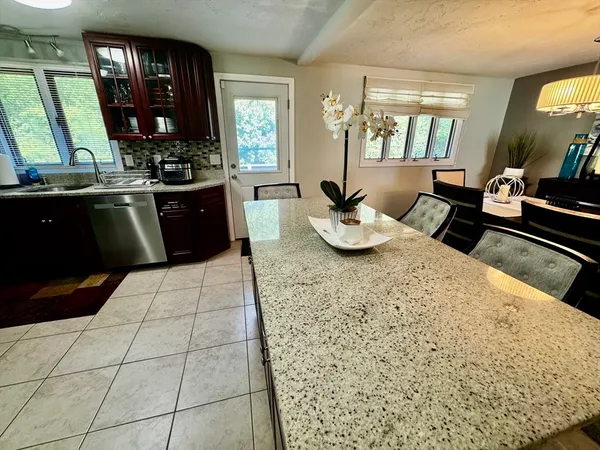 a kitchen with a sink and a stove top oven