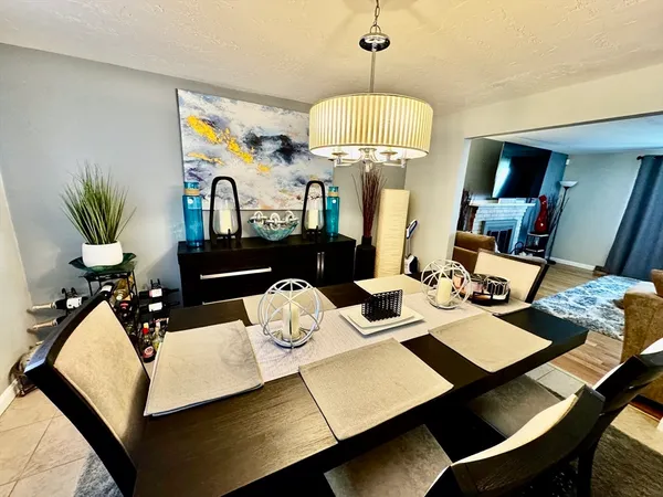 a view of a dining room with furniture a chandelier and wooden floor