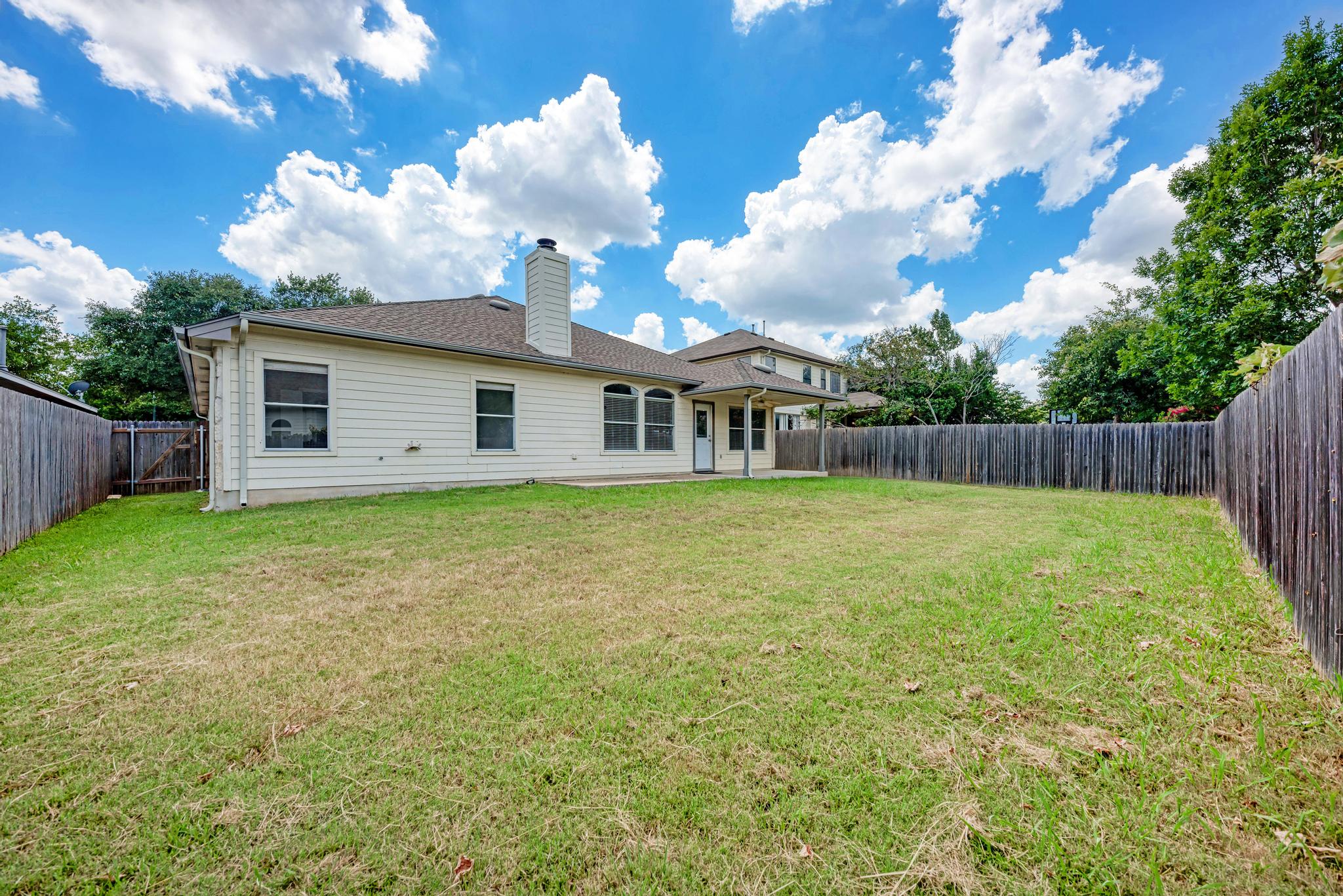 4408 Tello Path Austin, TX 78749 - Photo 35 of 38 Rear view of property featuring a fenced backyard, a chimney, a patio, and a shingled roof