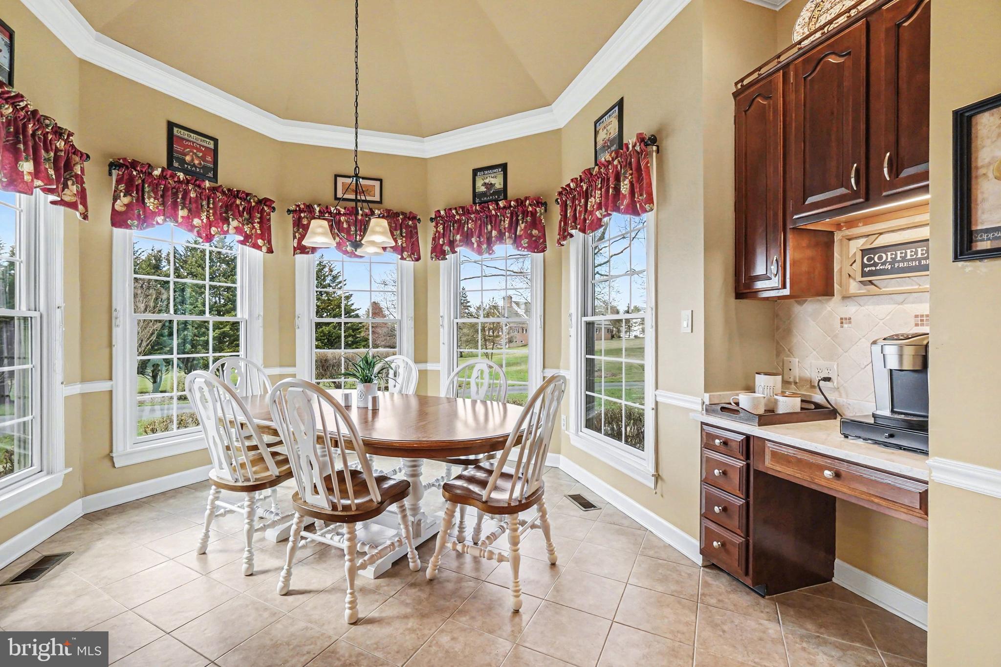 2309 Kings Arms Drive Fallston, MD 21047 - Photo 27 of 89 a view of a dining room with furniture large windows and wooden chandelier