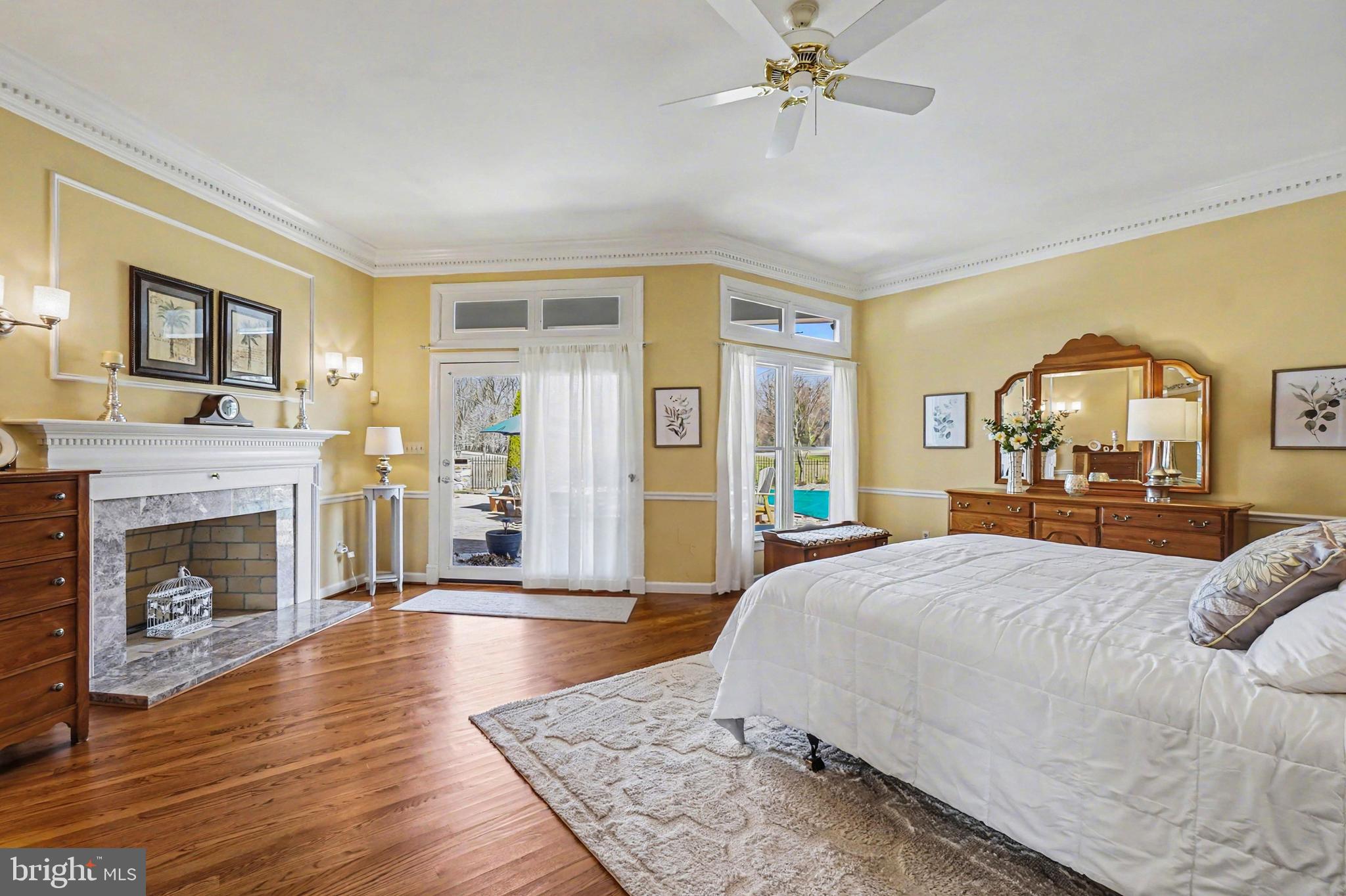 2309 Kings Arms Drive Fallston, MD 21047 - Photo 34 of 89 a spacious bedroom with a balcony a bed and a fireplace