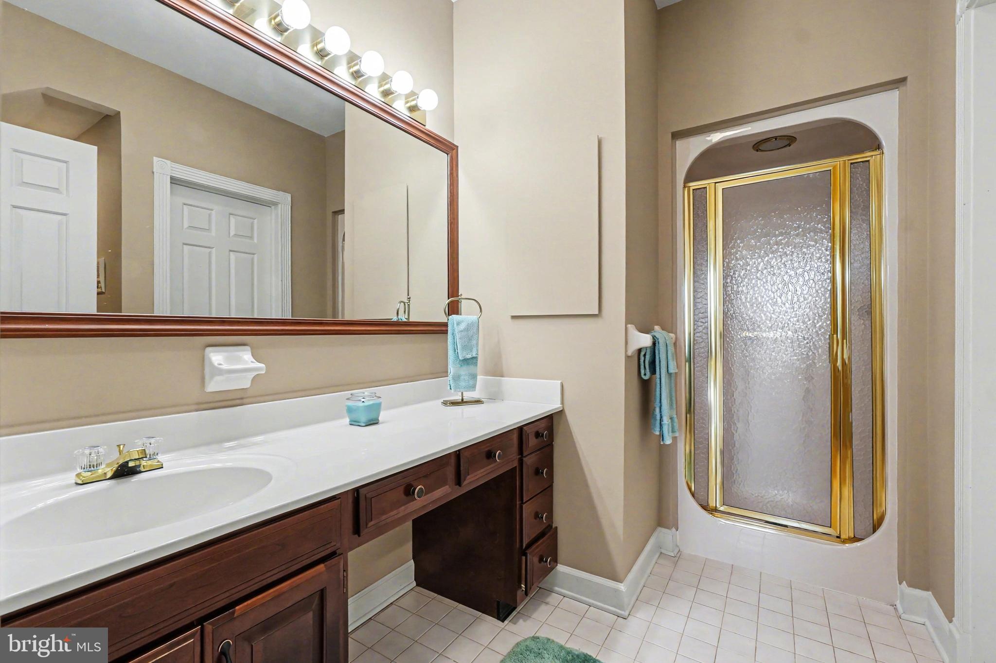 2309 Kings Arms Drive Fallston, MD 21047 - Photo 52 of 89 a bathroom with a double vanity sink a mirror and a bathtub