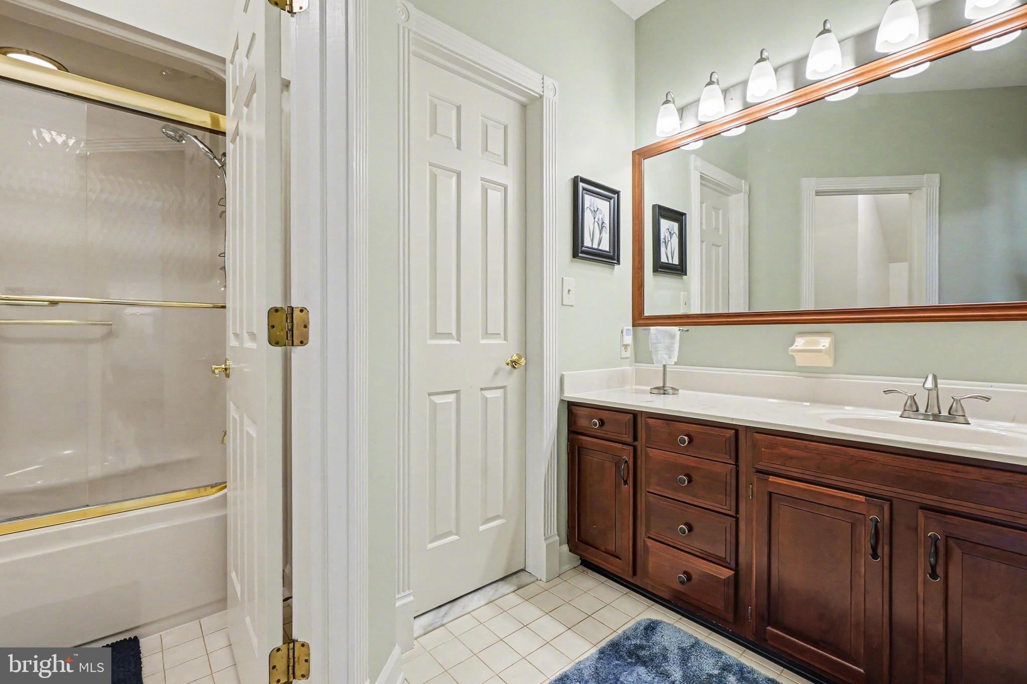 2309 Kings Arms Drive Fallston, MD 21047 - Photo 60 of 89 a spacious bathroom with a double vanity sink a large mirror and a bathtub