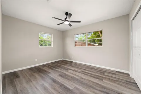 a view of an empty room with wooden floor