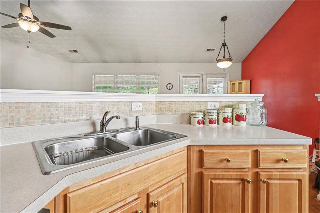 304 Allegheny Avenue Dallas, GA 30132 - Photo 11 of 30 a kitchen with a sink a counter and cabinets