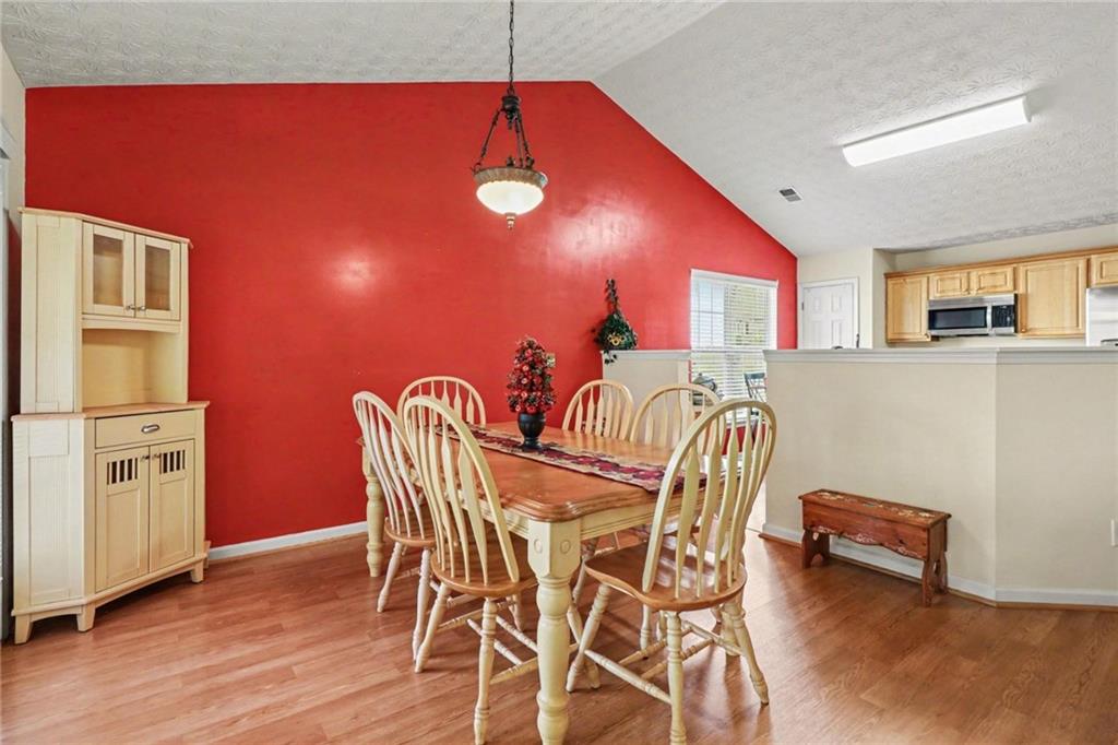 304 Allegheny Avenue Dallas, GA 30132 - Photo 12 of 30 a view of a dining room with furniture and wooden floor