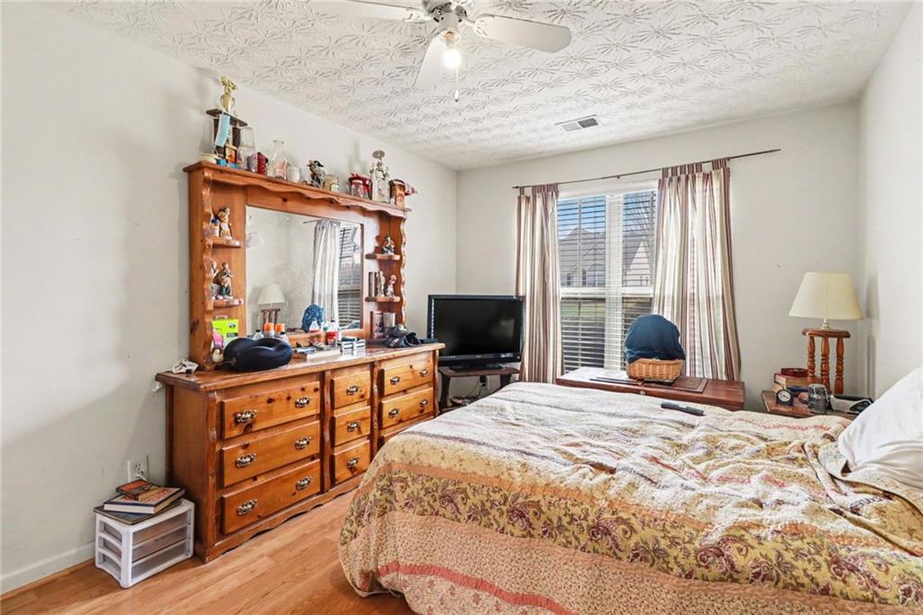 304 Allegheny Avenue Dallas, GA 30132 - Photo 16 of 30 a bedroom with a bed and a chandelier