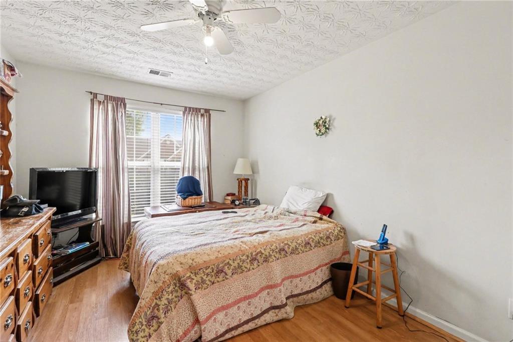 304 Allegheny Avenue Dallas, GA 30132 - Photo 17 of 30 a bedroom with a bed and wooden floor