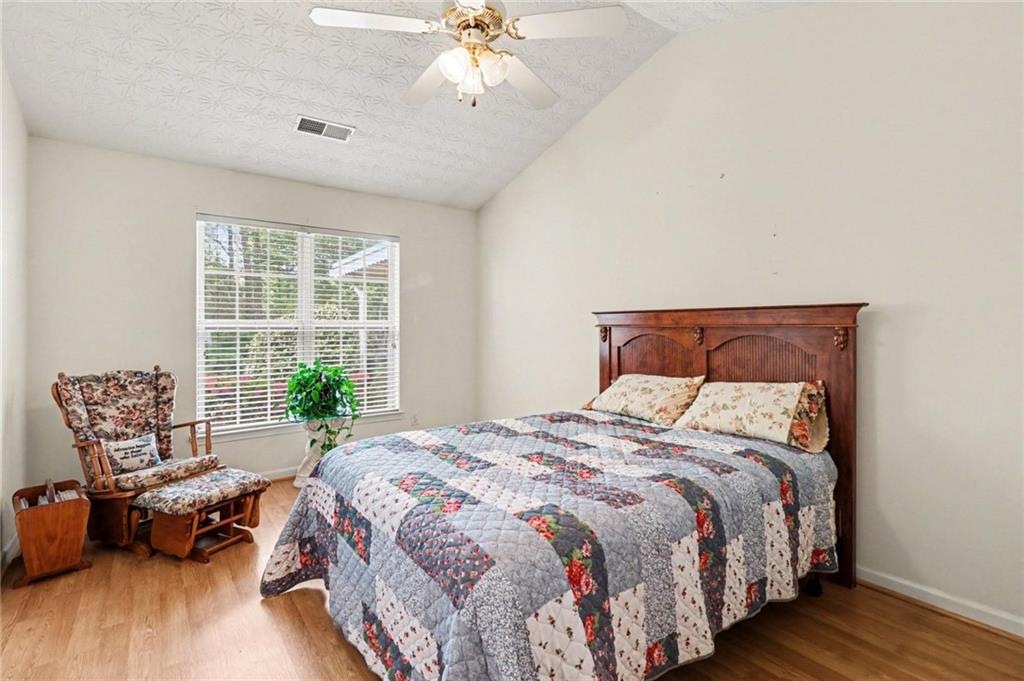 304 Allegheny Avenue Dallas, GA 30132 - Photo 18 of 30 a bedroom with bed and balcony with wooden floor