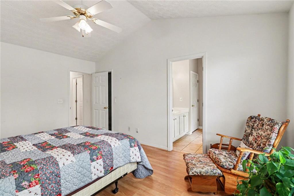 304 Allegheny Avenue Dallas, GA 30132 - Photo 19 of 30 a bedroom with a bed and a chandelier