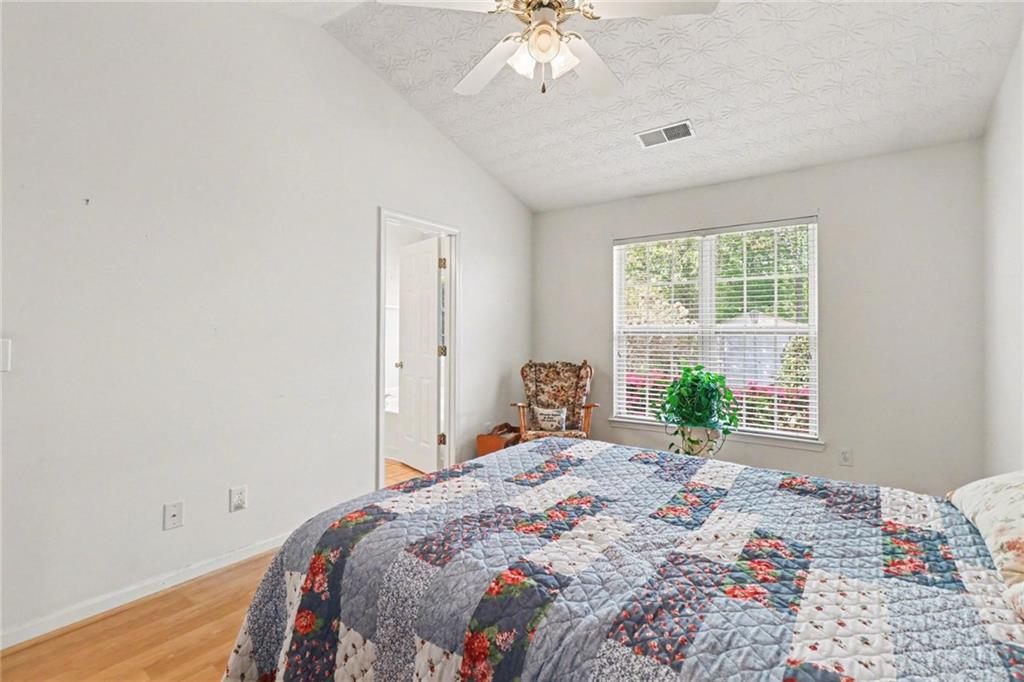 304 Allegheny Avenue Dallas, GA 30132 - Photo 20 of 30 a bedroom with a bed and a chandelier