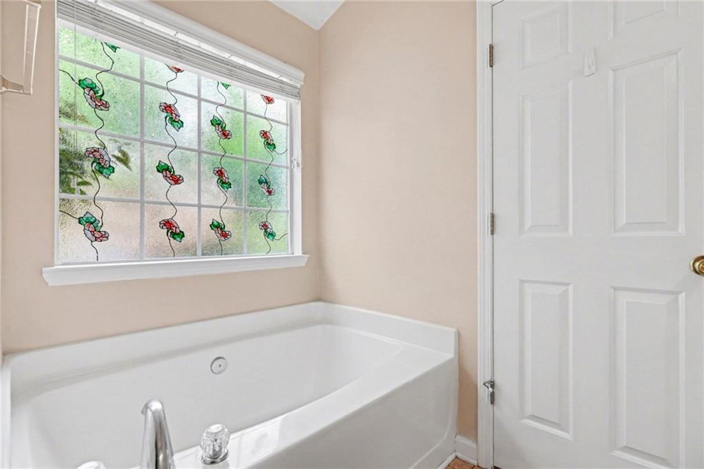 304 Allegheny Avenue Dallas, GA 30132 - Photo 22 of 30 a bathroom with a bathtub and window