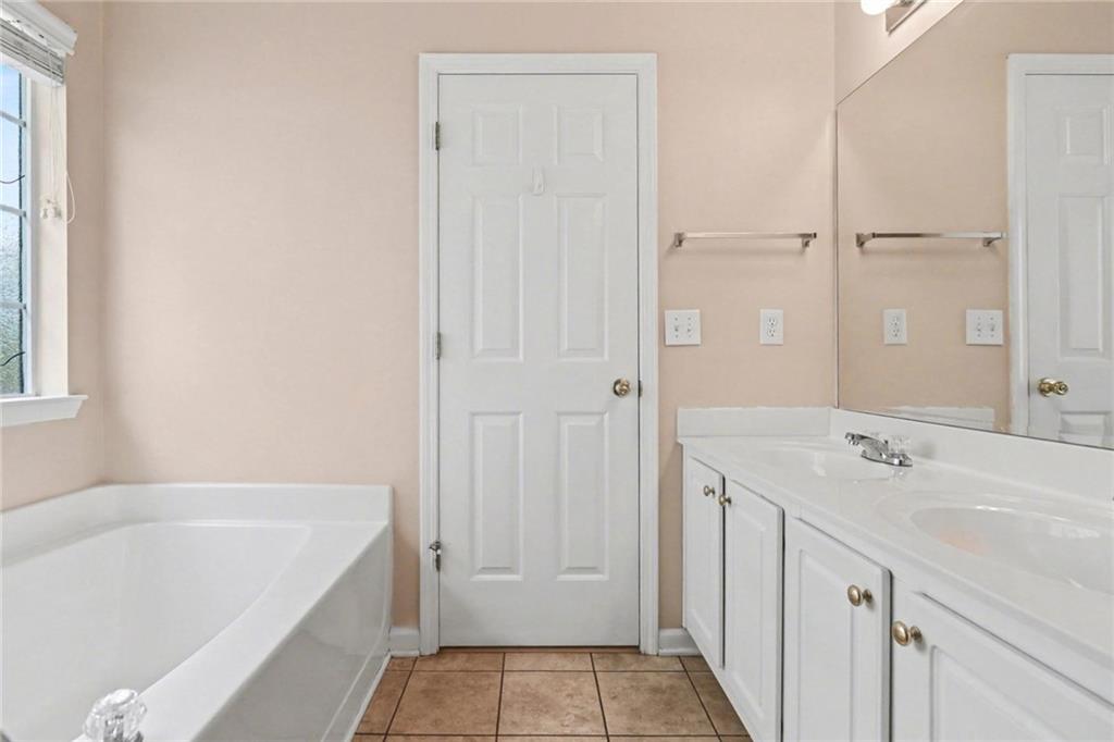 304 Allegheny Avenue Dallas, GA 30132 - Photo 23 of 30 a bathroom with a tub sink and mirror