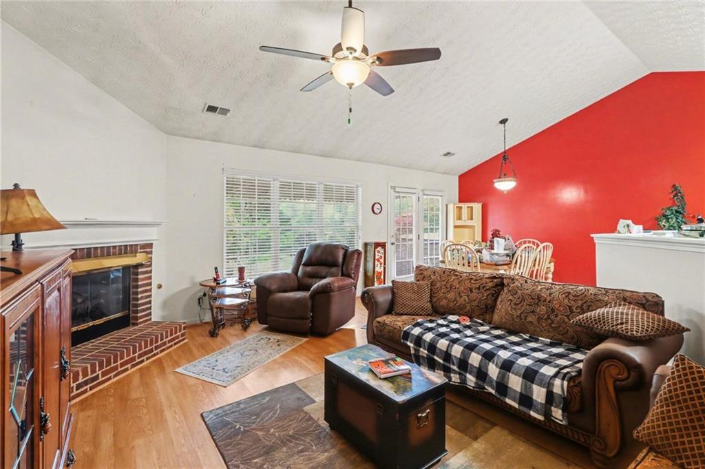 304 Allegheny Avenue Dallas, GA 30132 - Photo 5 of 30 a living room with furniture a fireplace with wooden floor