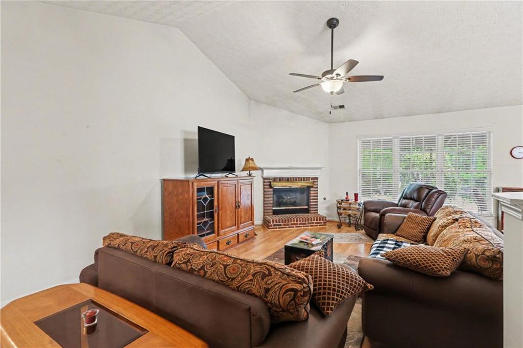 304 Allegheny Avenue Dallas, GA 30132 - Photo 7 of 30 a living room with furniture a fireplace and a flat screen tv
