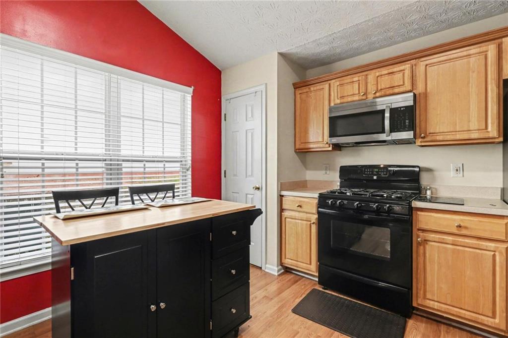 304 Allegheny Avenue Dallas, GA 30132 - Photo 8 of 30 a kitchen with a stove and a microwave