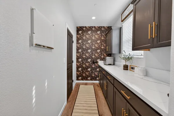 a living room with furniture and view of kitchen