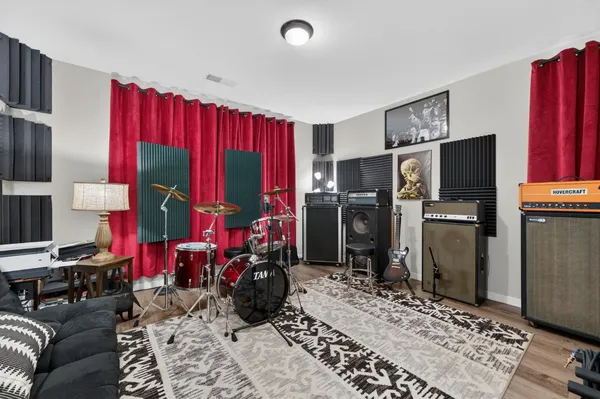 a living room with furniture a rug and a closet