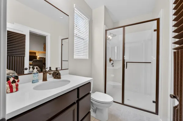 a bedroom with a bed and a chair