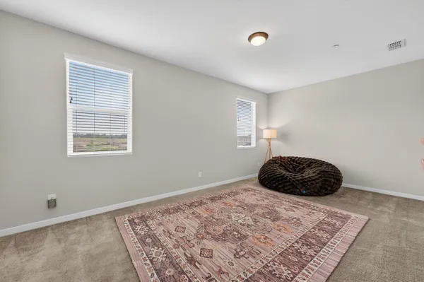 a bedroom with a bed chair and a window