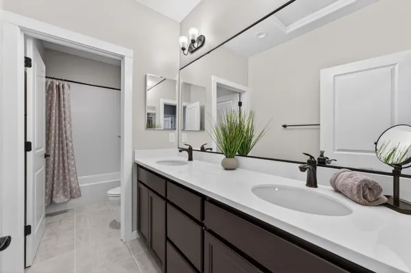 a white bath tub sitting next to a white toilet