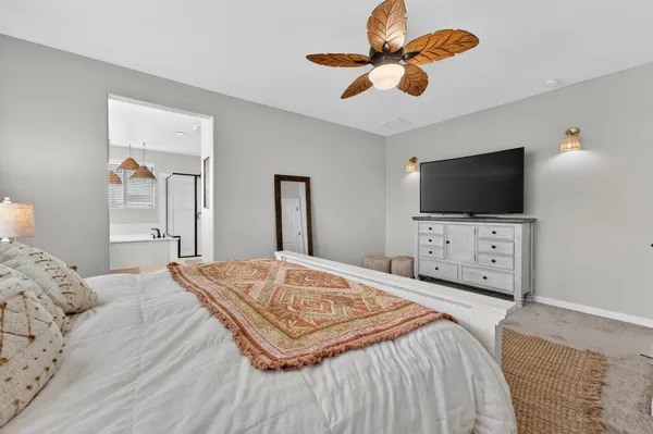 a spacious bathroom with a double vanity sink mirror and bathtub