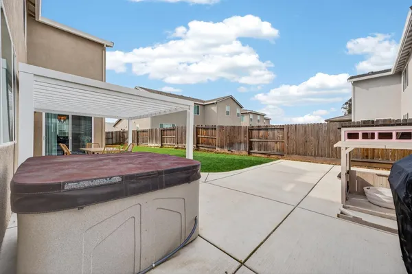 a backyard of a house with table and chairs