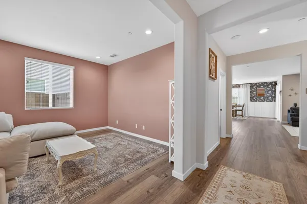 a living room with furniture and a wooden floor