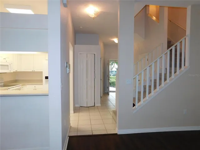 an empty room with a ceiling fan and a window