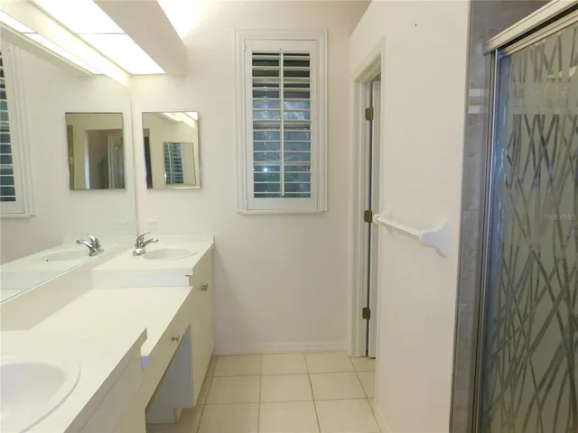 a room with a sink and mirror