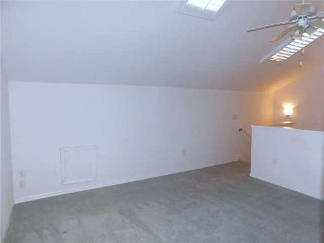 a view of empty room with ceiling fan