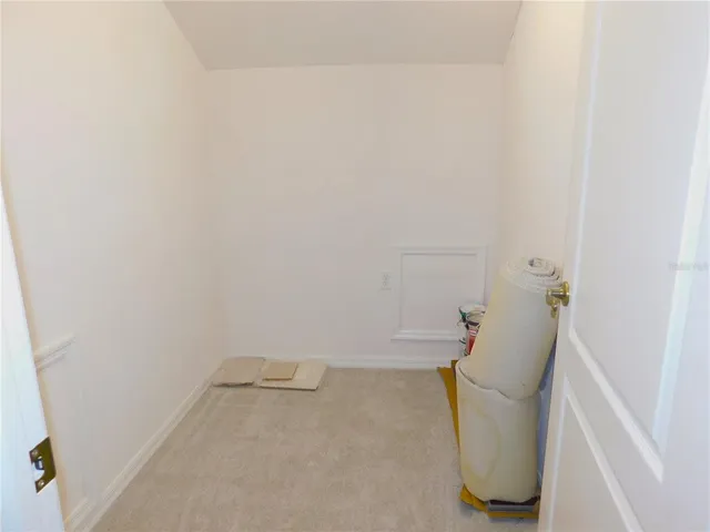a view of a house with a yard and potted plants
