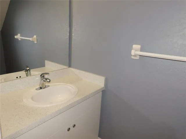 a white toilet sitting next to a white walls