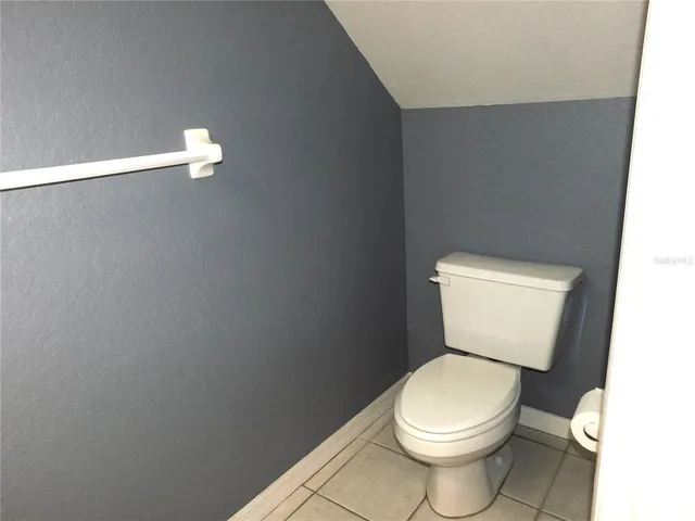 a view of staircase with white walls and white door