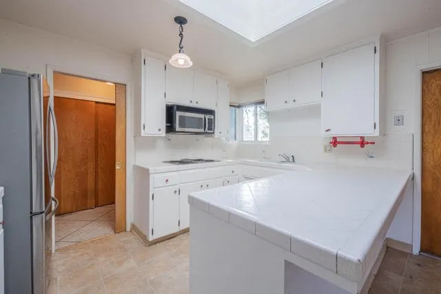 a kitchen with a sink appliances and cabinets