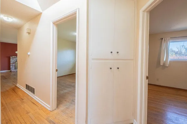 a view of a hallway with wooden floor