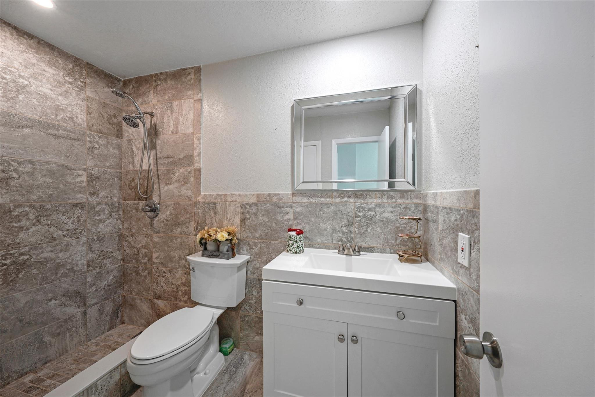 230 West 68th Street, Unit 208 Hialeah, FL 33014 - Photo 17 of 23 a bathroom with a toilet sink and mirror