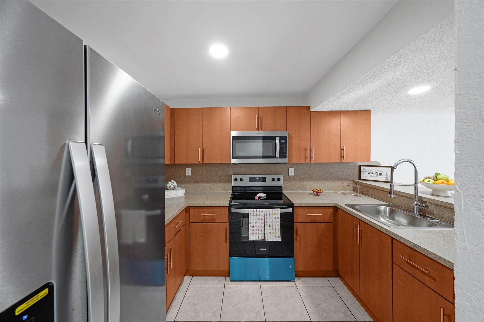 230 West 68th Street, Unit 208 Hialeah, FL 33014 - Photo 6 of 23 a kitchen with stainless steel appliances granite countertop a refrigerator a stove top oven a sink and dishwasher