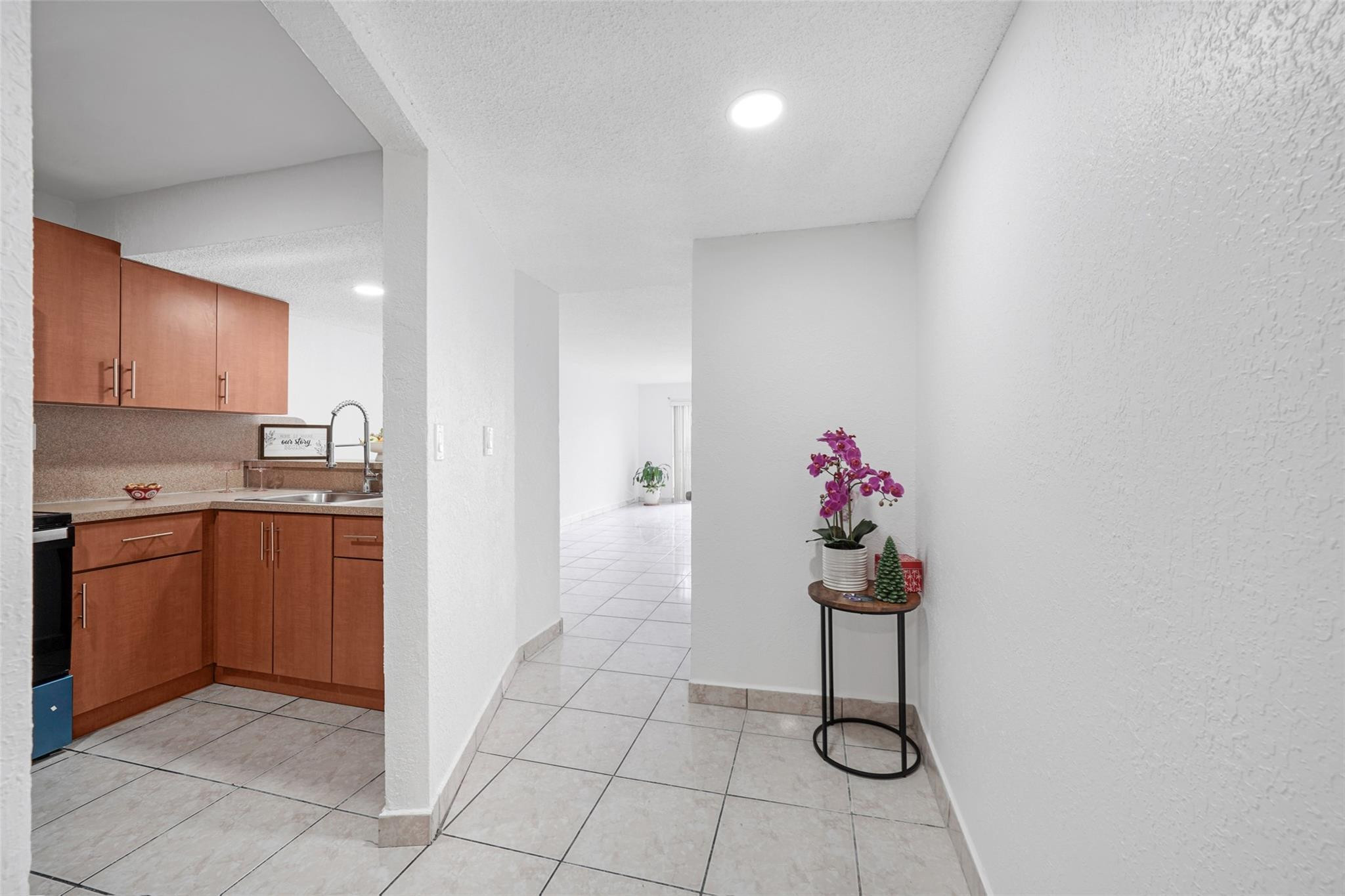 230 West 68th Street, Unit 208 Hialeah, FL 33014 - Photo 8 of 23 a kitchen with a sink and cabinets