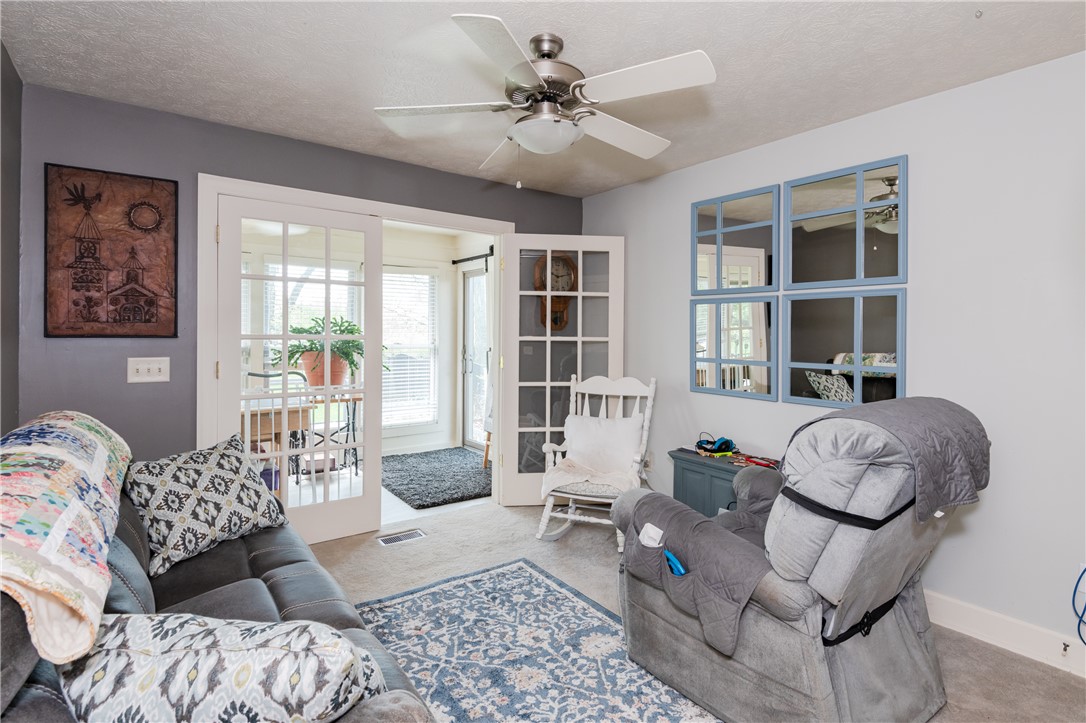 159 East Lytle 5 Points Road Springboro, OH 45066 - Photo 14 of 45 This inviting living space features French doors and a ceiling fan, creating an airy and comfortable atmosphere.