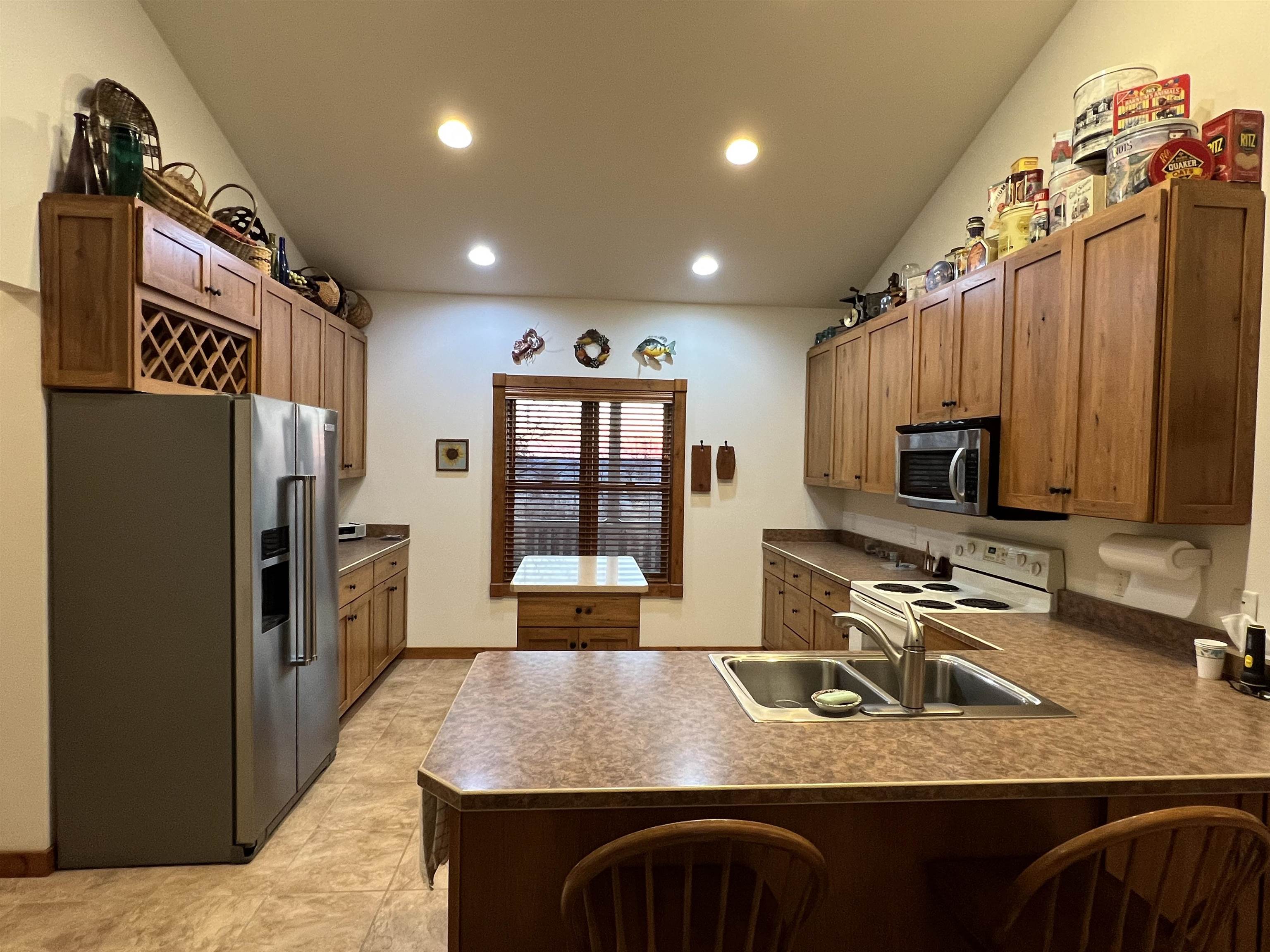 4707 South Elmoville Road Stockton, IL 61085 - Photo 12 of 43 a kitchen with stainless steel appliances granite countertop a sink refrigerator stove and microwave